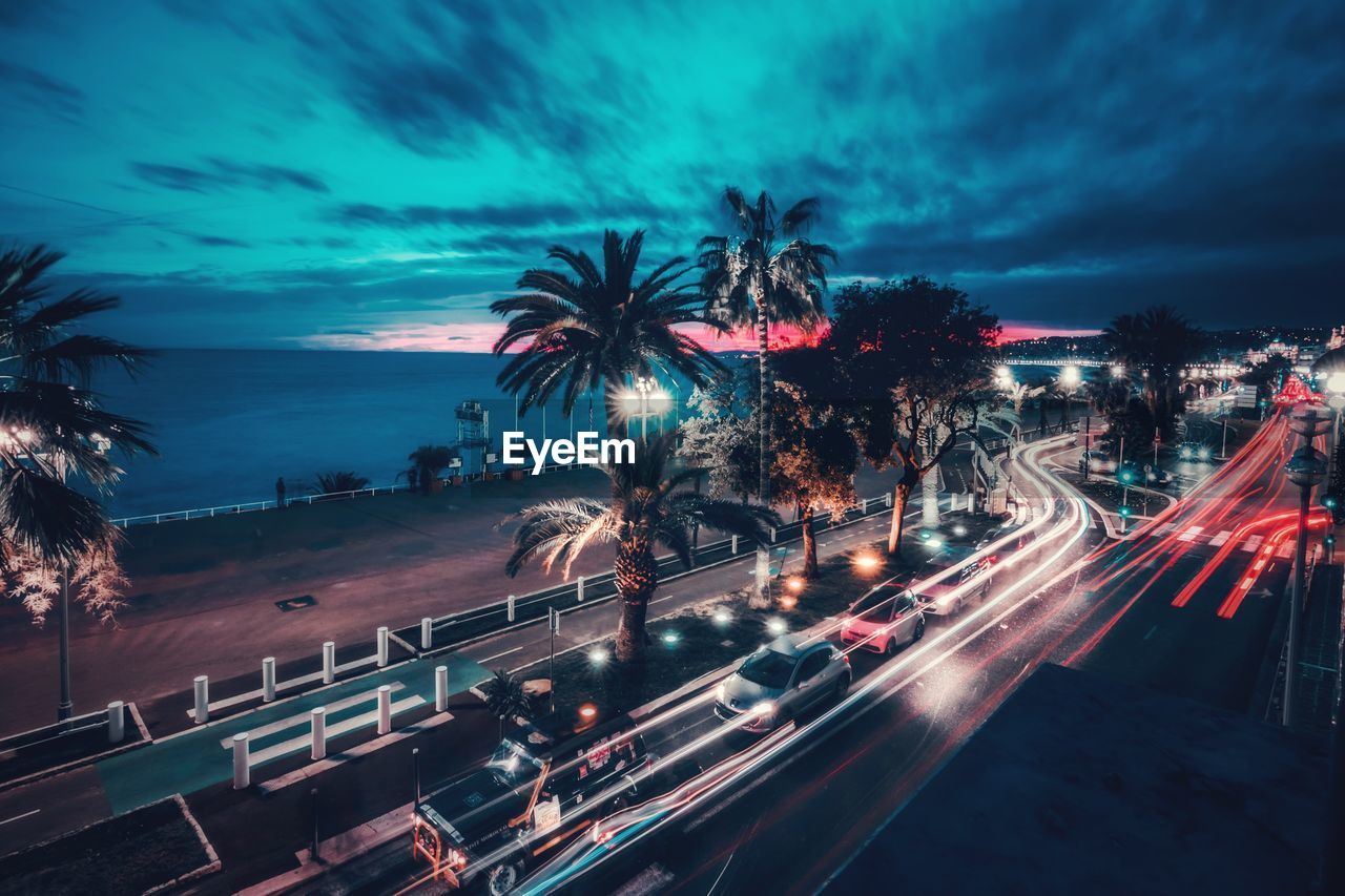 Light trails on road against sky at night