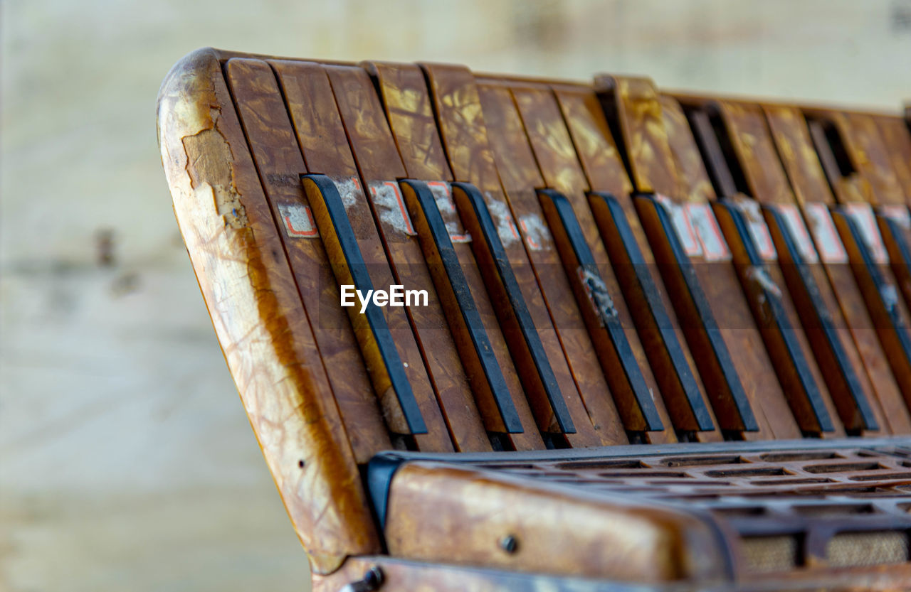 CLOSE-UP OF ABANDONED BENCH