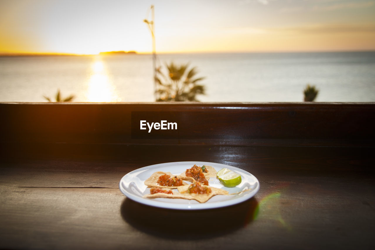 Food in plate on table against sea