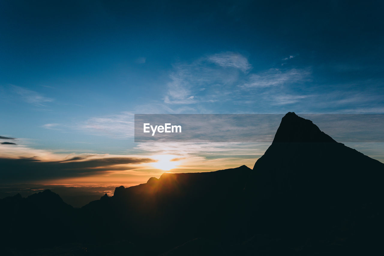 SILHOUETTE MOUNTAINS AGAINST SKY DURING SUNSET