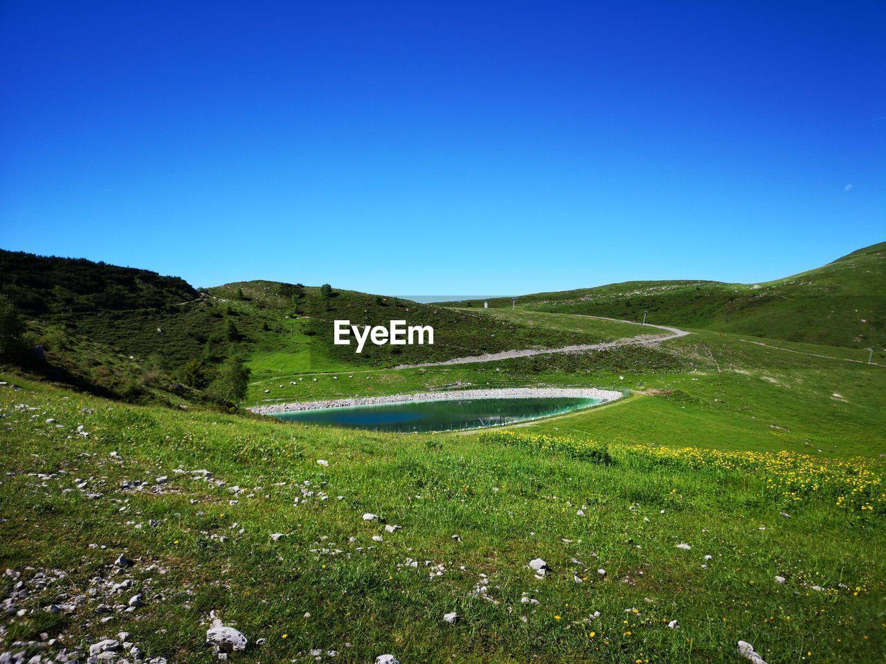 SCENIC VIEW OF LAND AGAINST CLEAR BLUE SKY