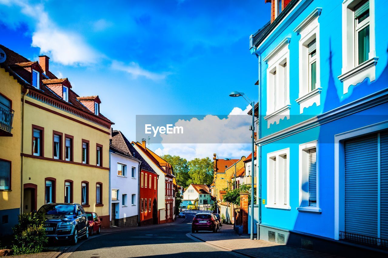 Street amidst buildings in city against sky