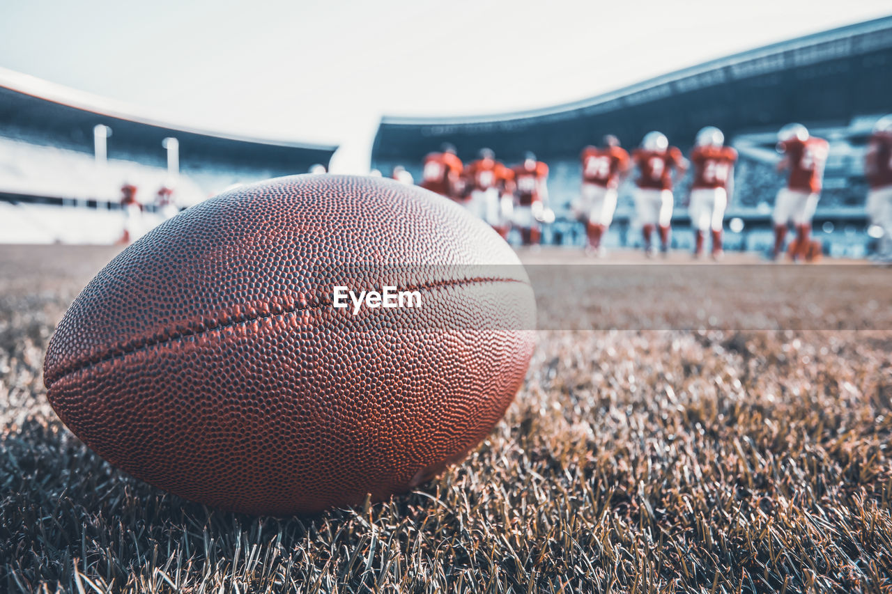 CLOSE-UP OF BALL ON FIELD BY LAND