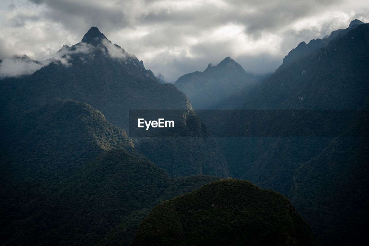 Mountain range with sunbeam near of machu picchu, peru