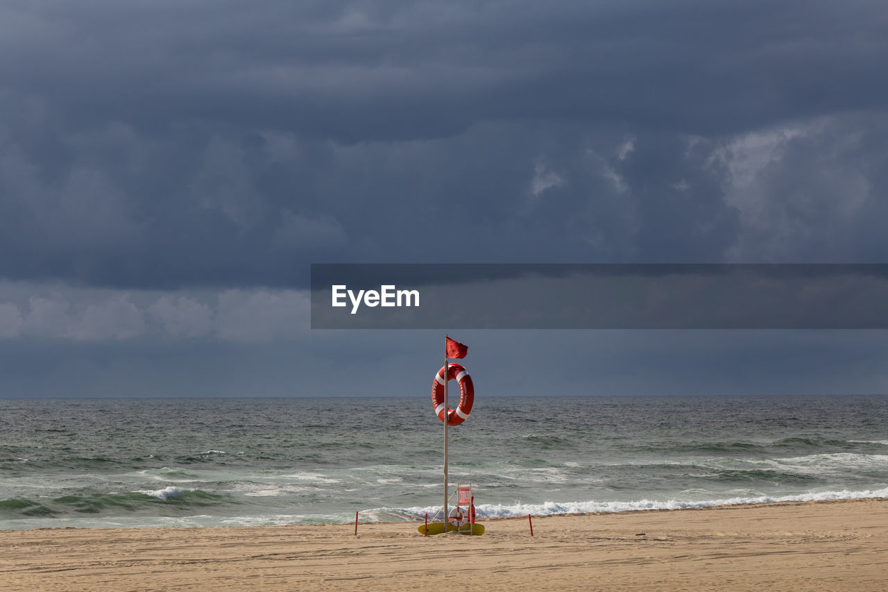 Lifeguard hut at sea against sky