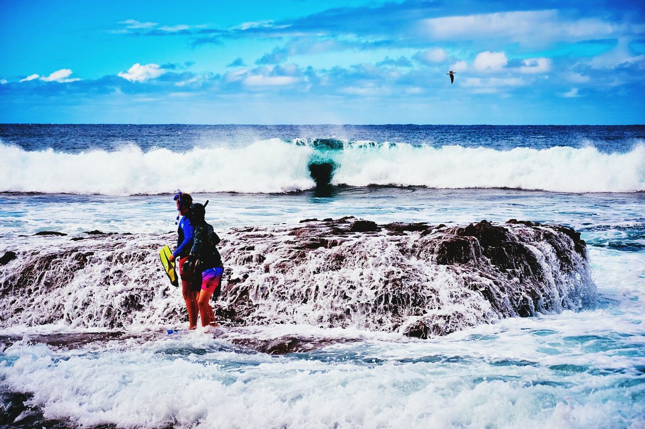 Two people wearing snorkeling equipment in sea