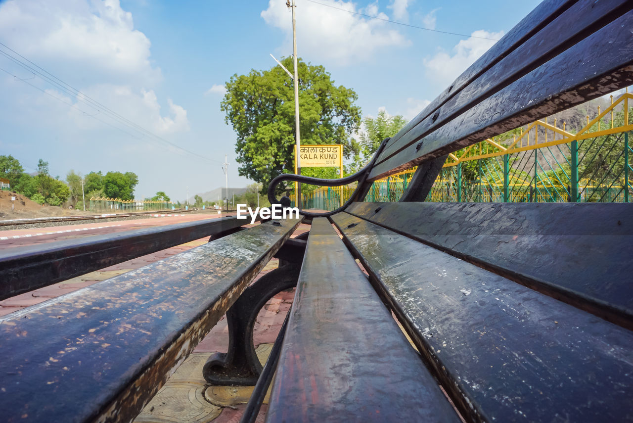 sky, transport, track, nature, cloud, plant, architecture, rail transportation, railroad track, transportation, tree, built structure, reflection, day, outdoors, bridge, no people, urban area, environment, water, travel, sunlight, city, blue, environmental conservation