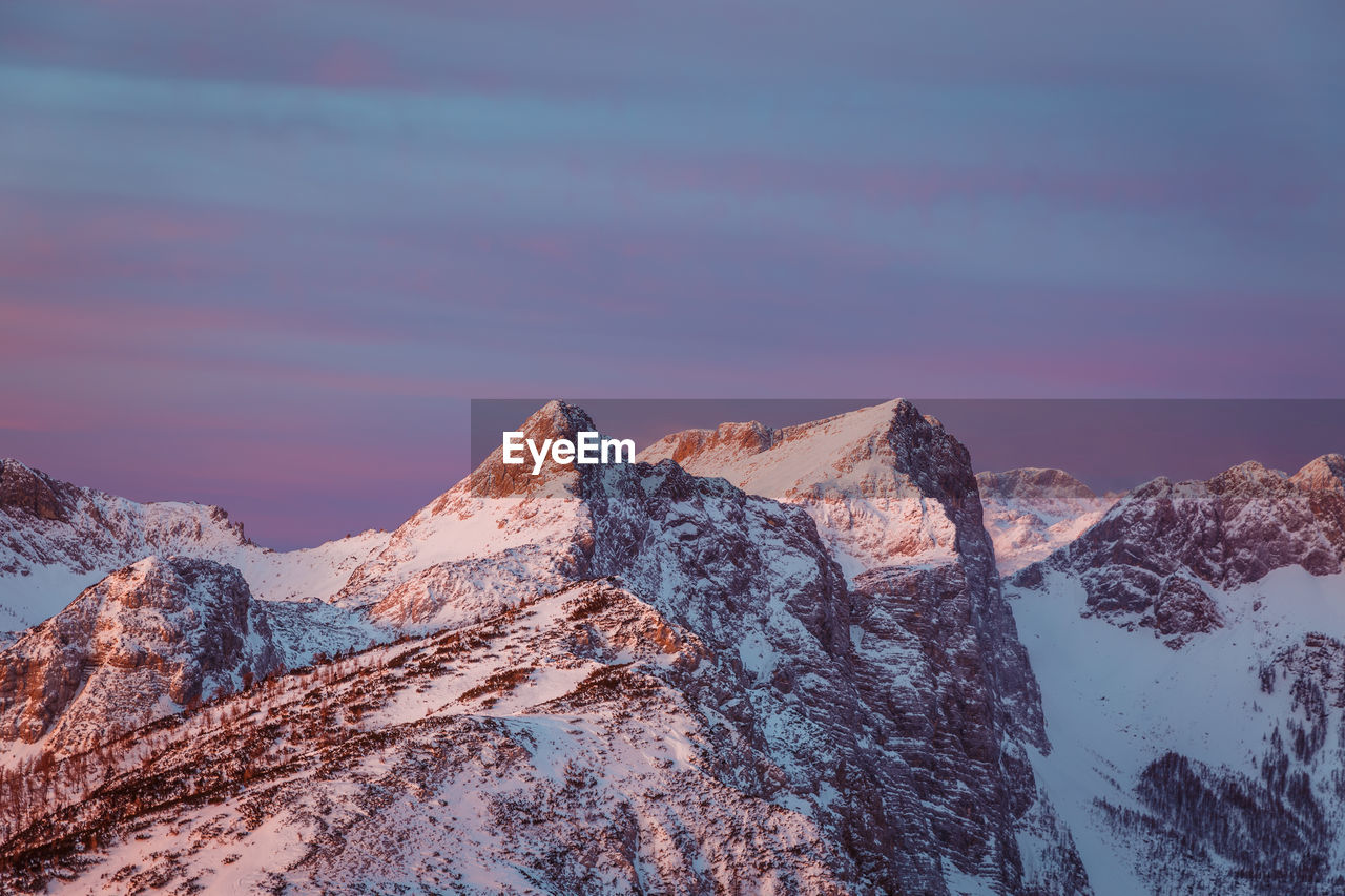 Scenic view of snowcapped mountains against sky during winter