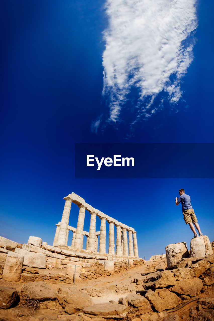 LOW ANGLE VIEW OF BUILT STRUCTURE AGAINST BLUE SKY