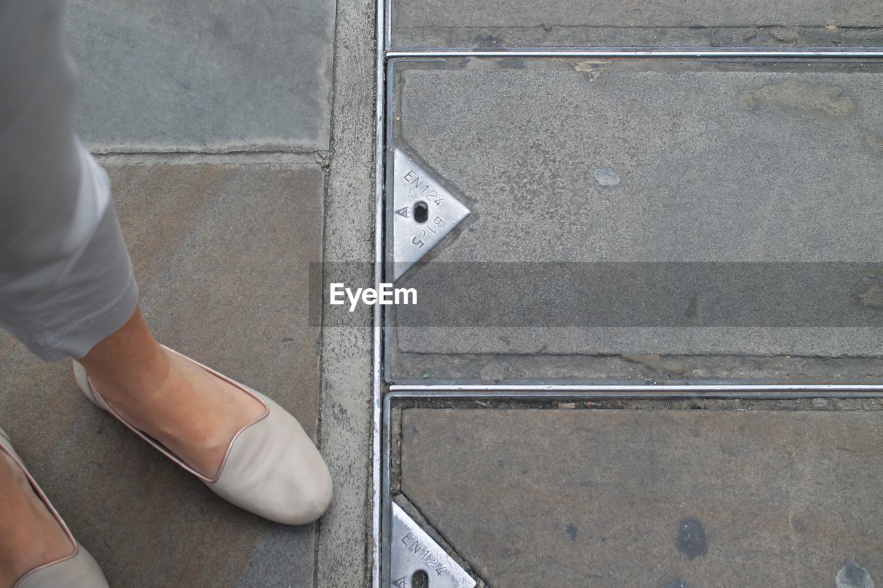 LOW SECTION OF MAN STANDING ON STREET