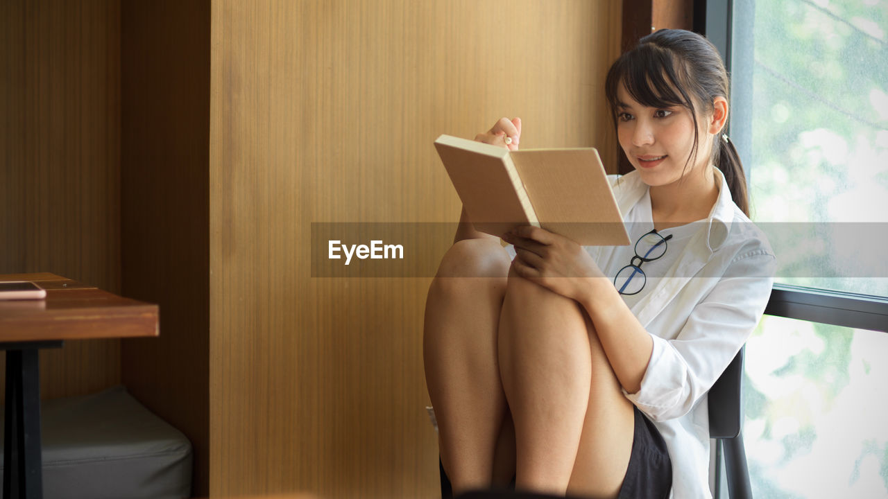 Young woman looking at book