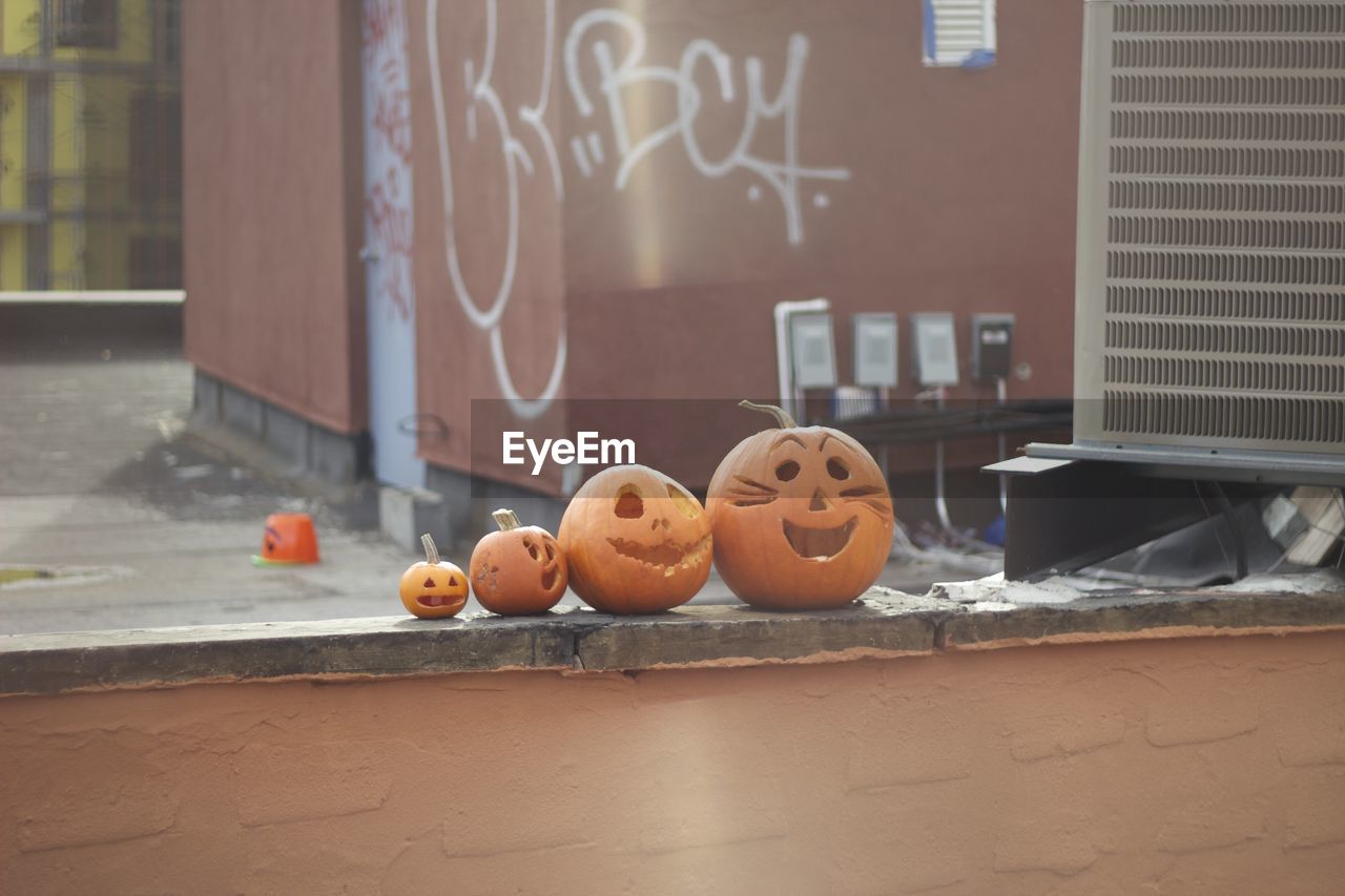 High angle view of jack o lanterns on retaining wall against building