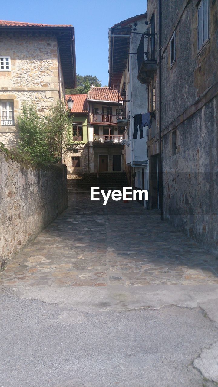 Walkway amidst buildings in town