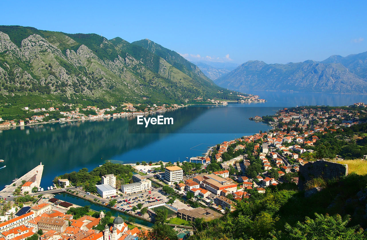 Houses by river and mountains at kotor bay