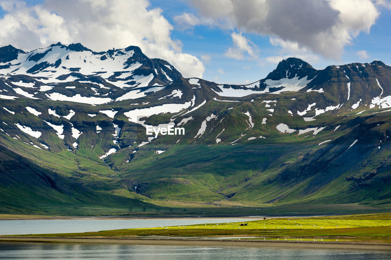 SCENIC VIEW OF LAKE BY MOUNTAIN AGAINST SKY