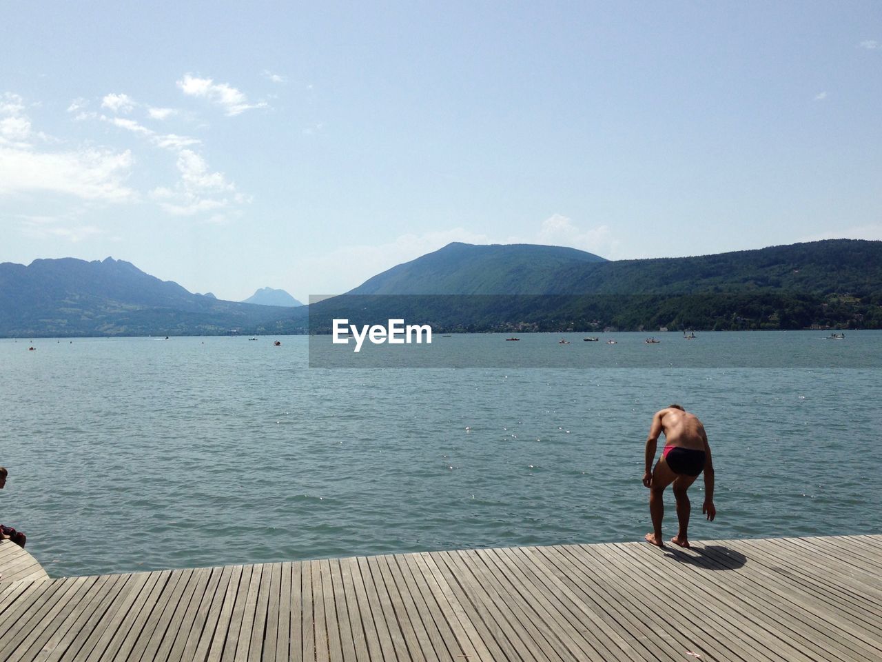 MAN ON LAKE AGAINST SKY