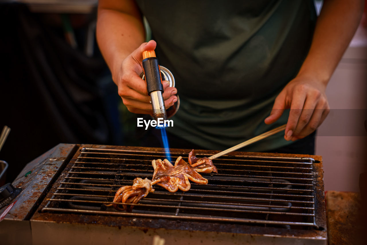 Midsection of man preparing food