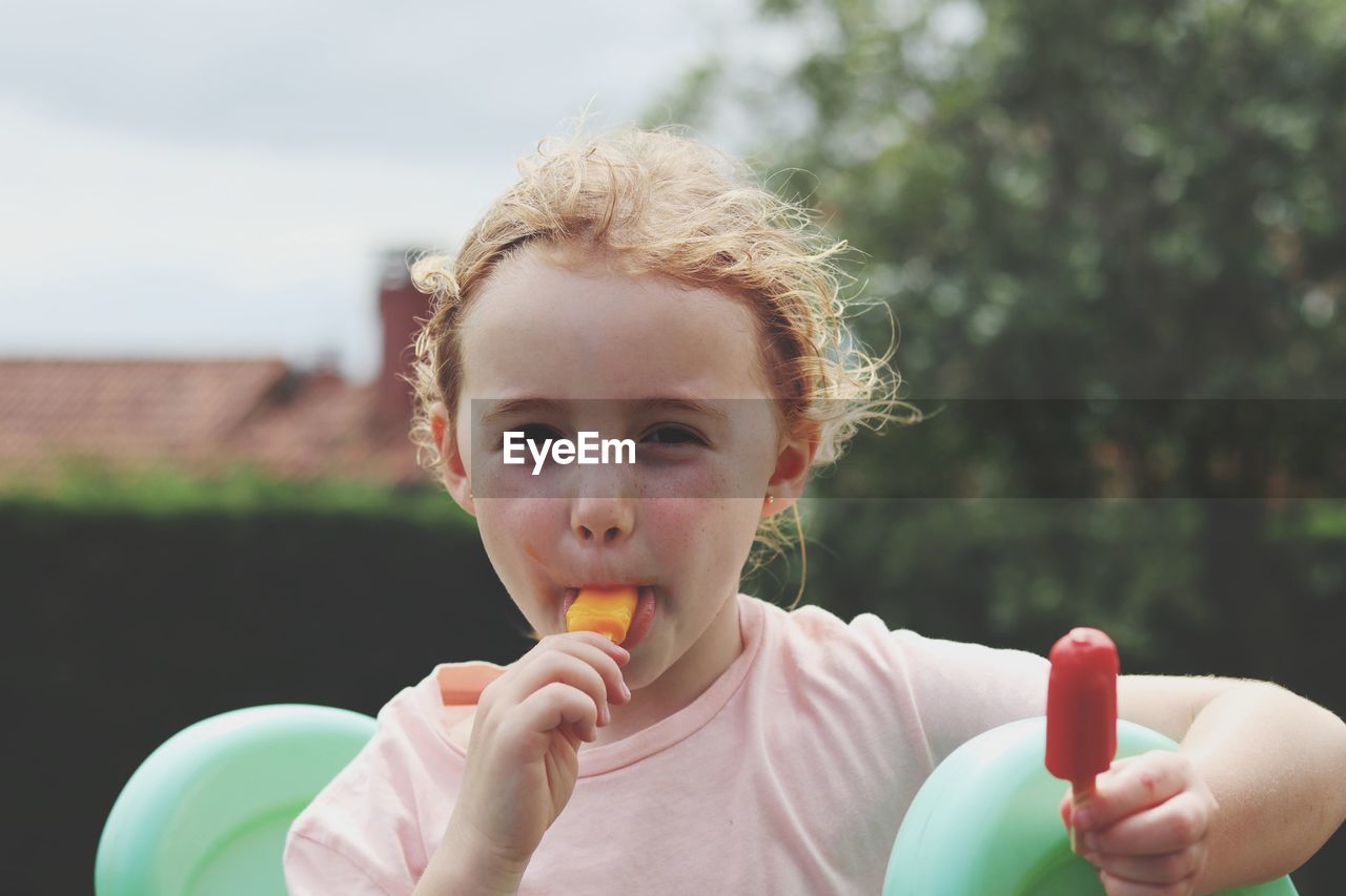 Portrait of cute girl eating an ice cream