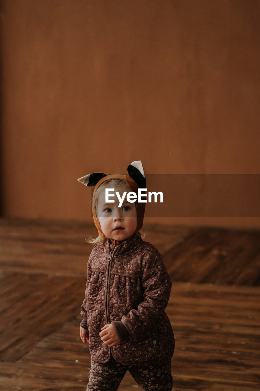 Toddler baby girl in funny hat with ears having fun