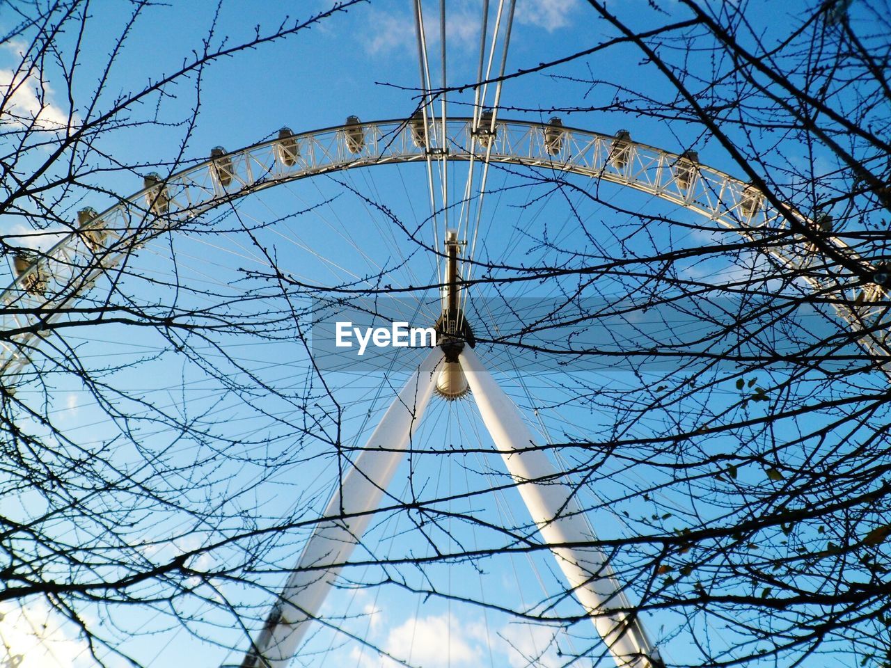 Low angle view of london eye against sky during winter