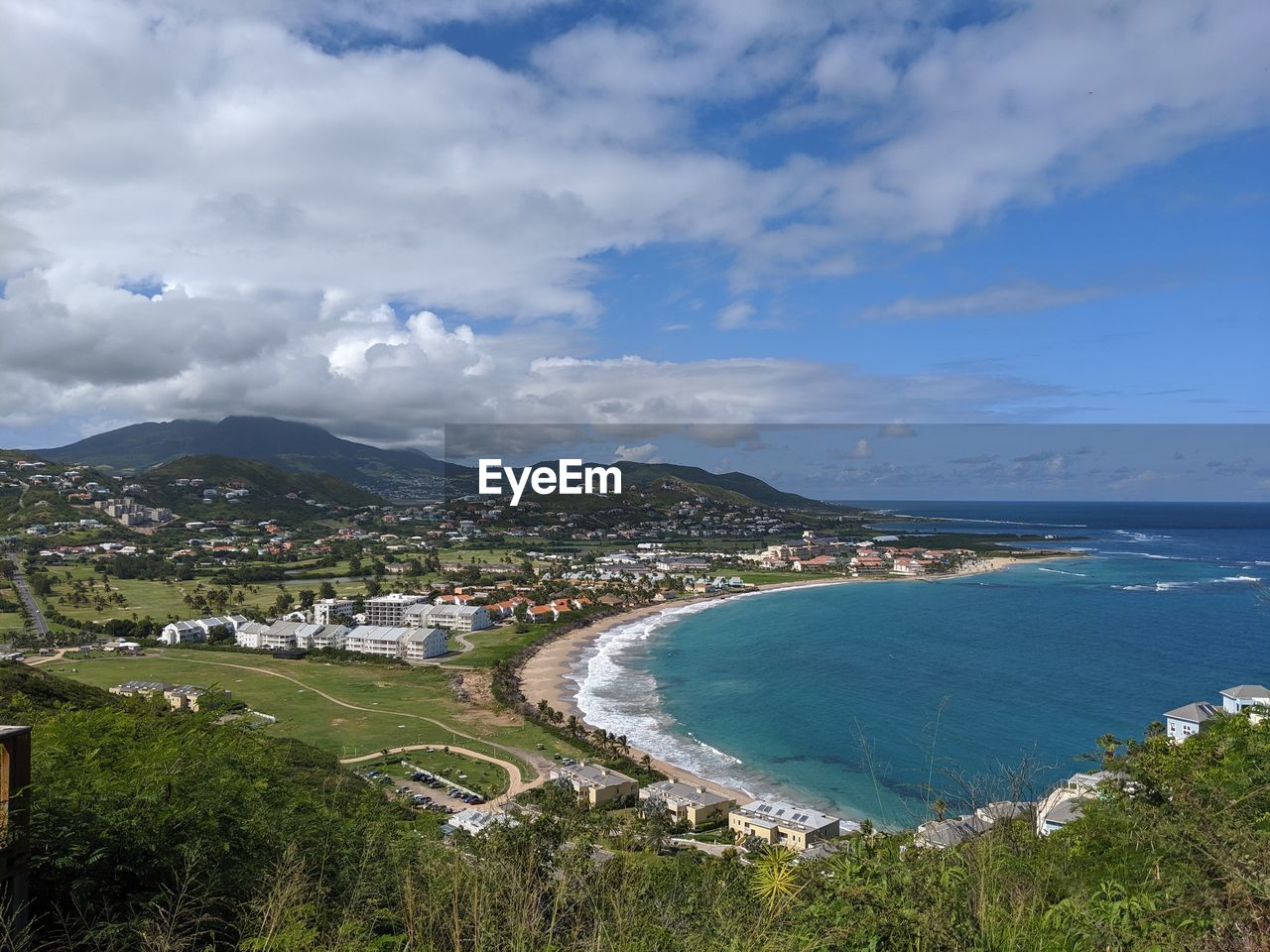 Scenic view of sea and buildings against sky