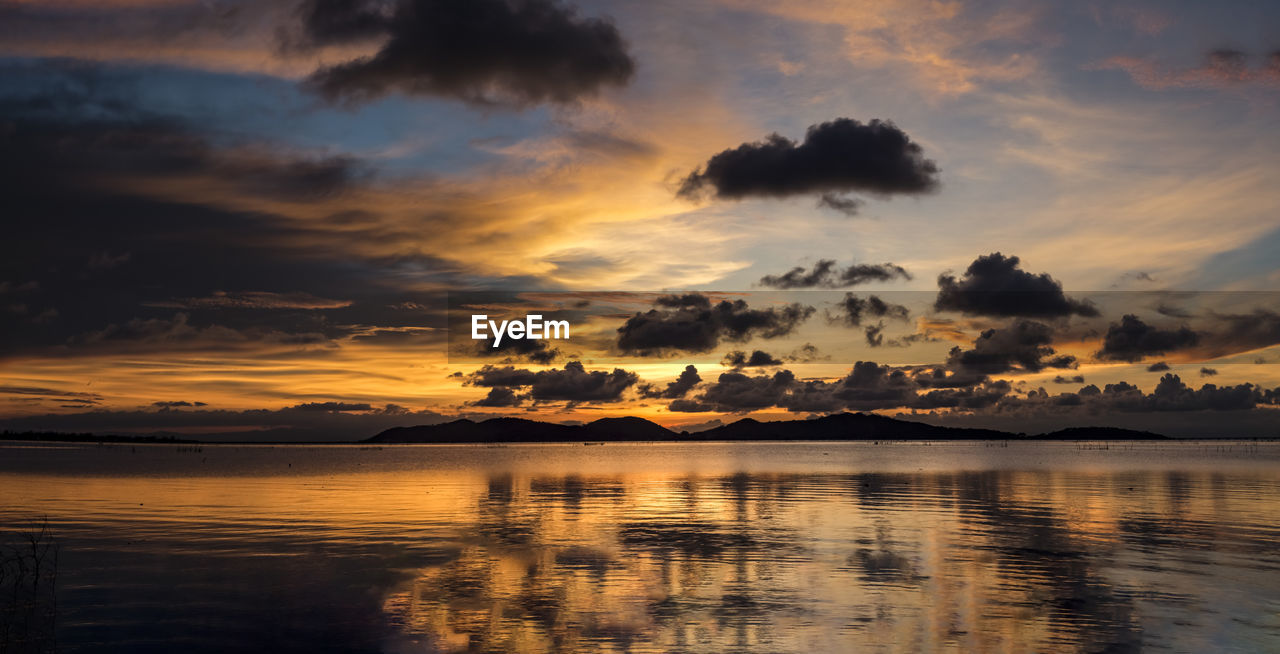 Scenic view of lake against sky during sunset