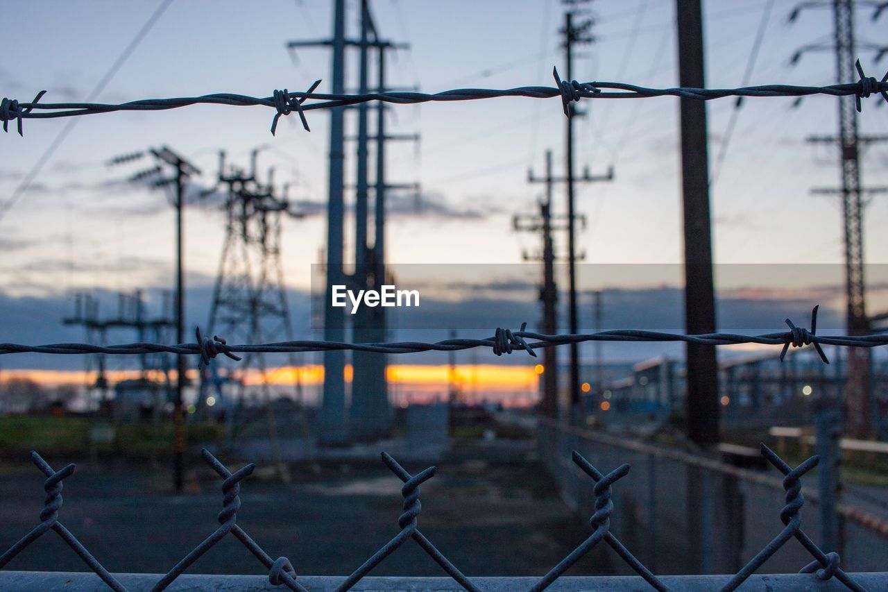 Close-up of barbed wire against sky