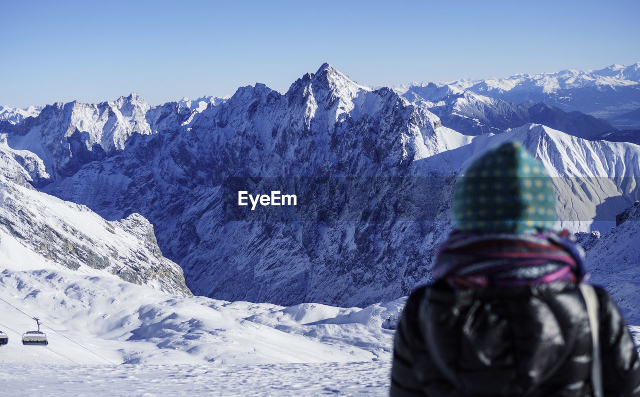 Rear view of a person on snow covered landscape