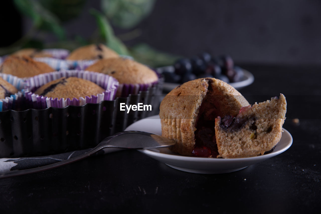 Delicious homemade cupcakes filled with blueberries and presented in small molds.