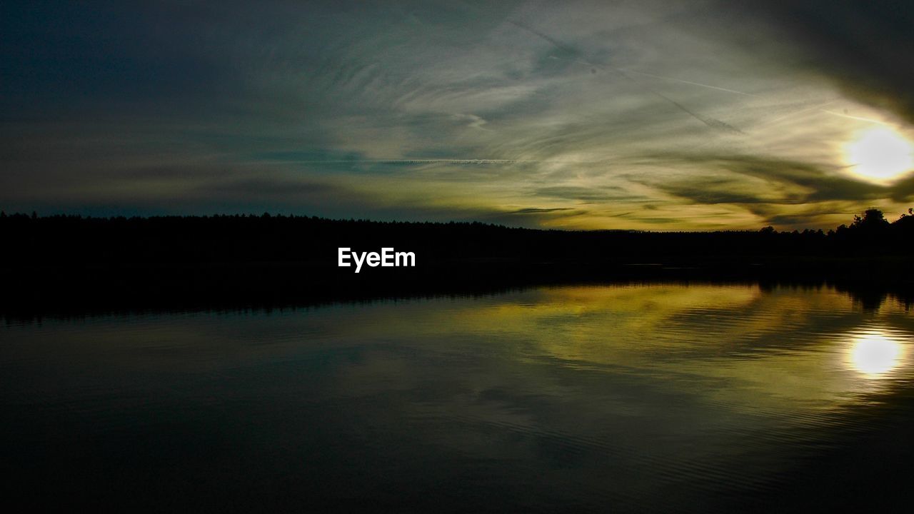 SCENIC VIEW OF LAKE AT SUNSET