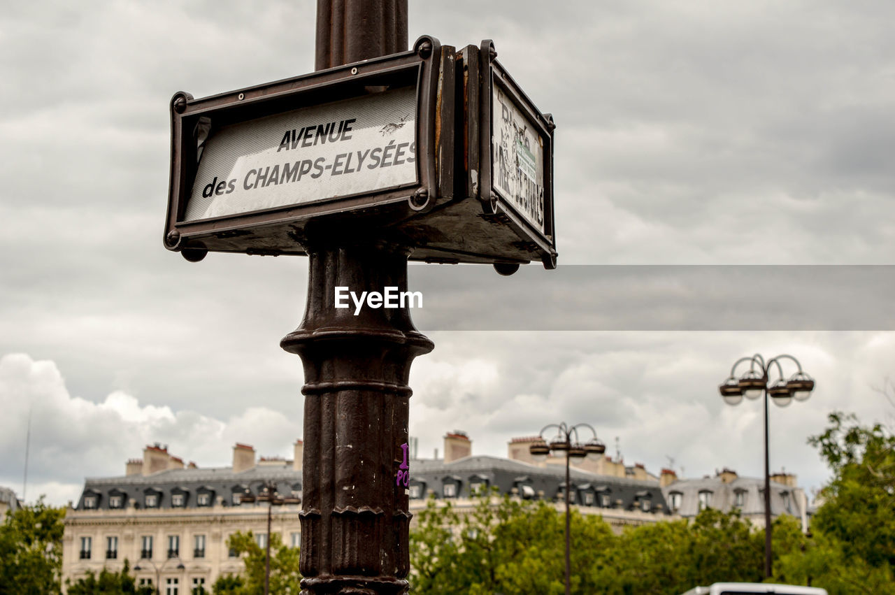 LOW ANGLE VIEW OF SIGN AGAINST THE SKY