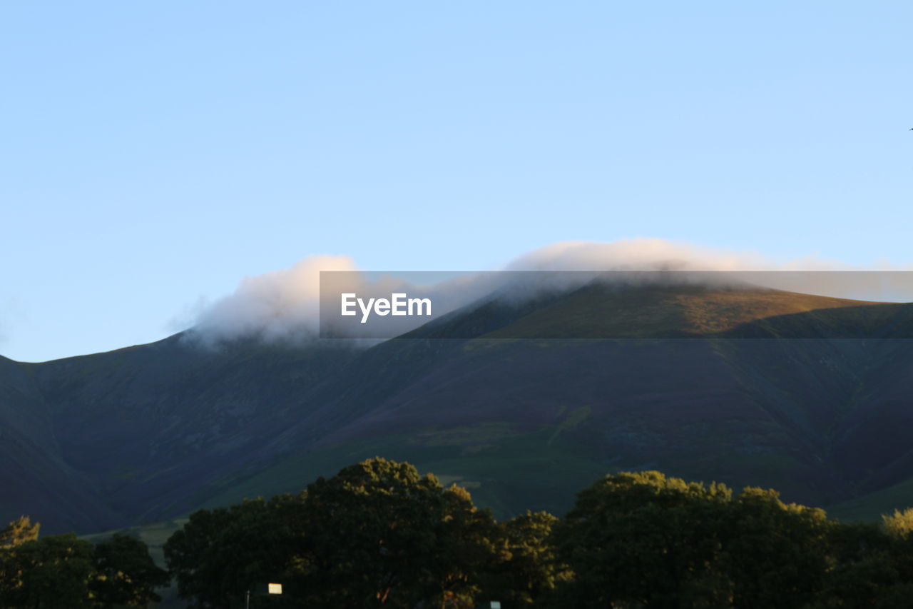 Scenic view of mountains against cloudy sky