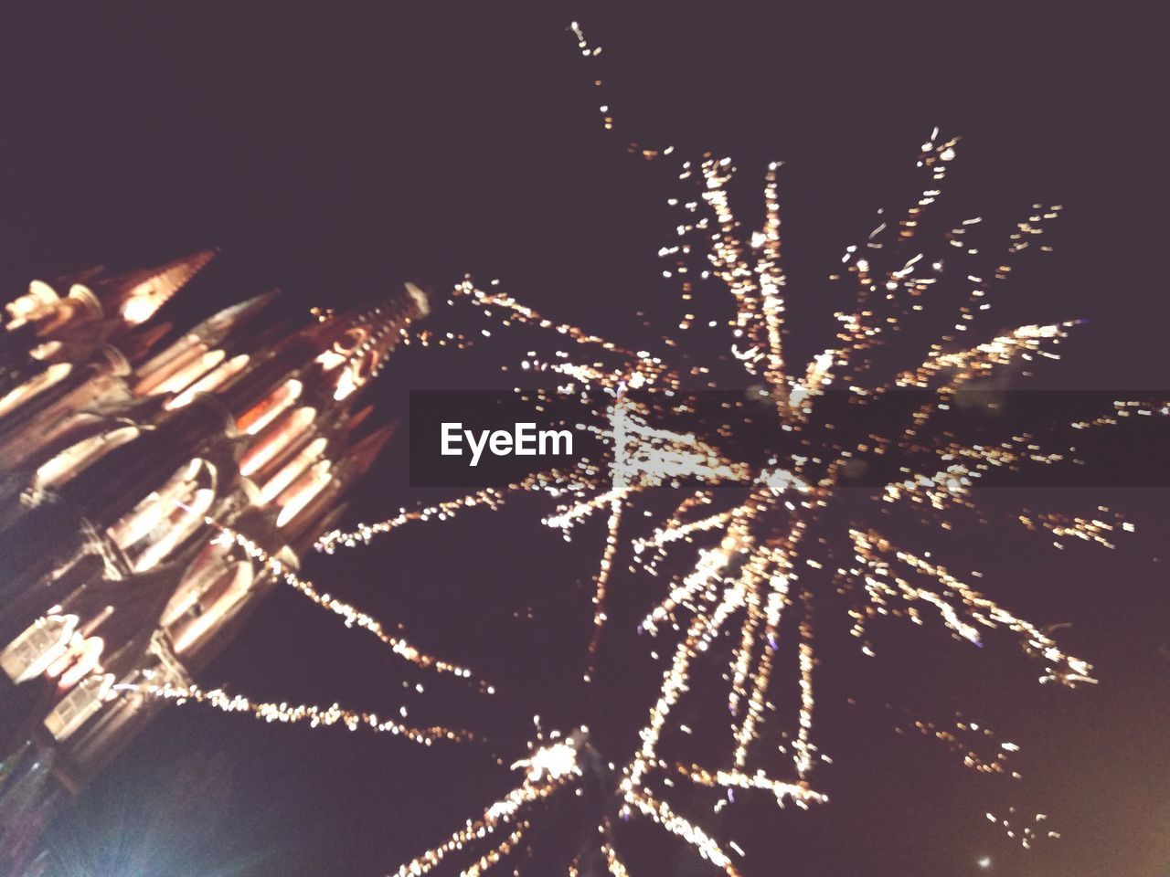 LOW ANGLE VIEW OF FIREWORKS DISPLAY AT NIGHT