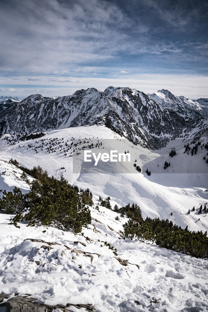 Scenic view of snow covered mountains against sky