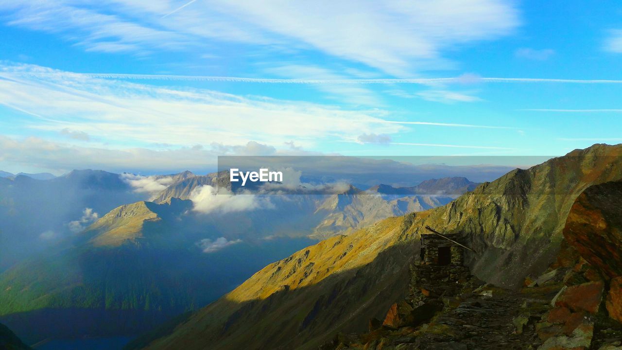 Scenic view of mountains against cloudy sky