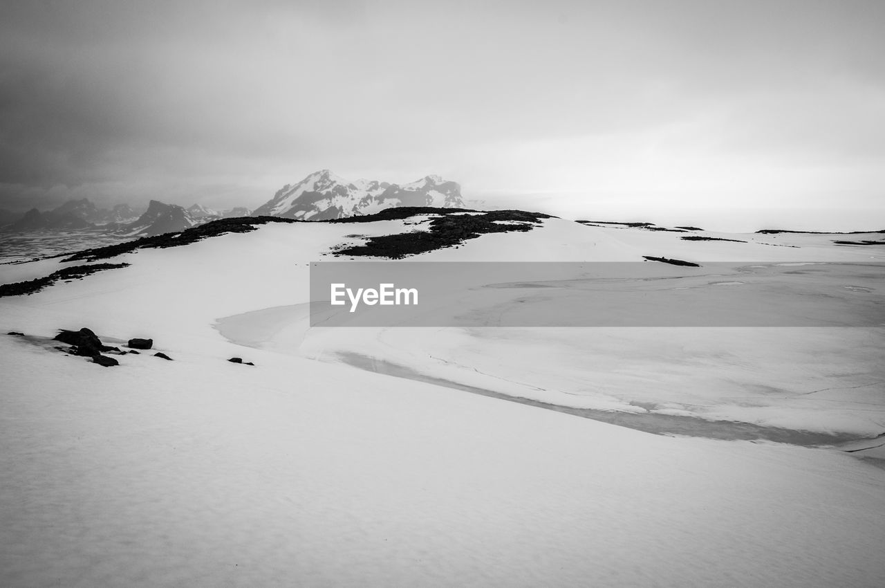 Scenic view of snow covered mountain against sky