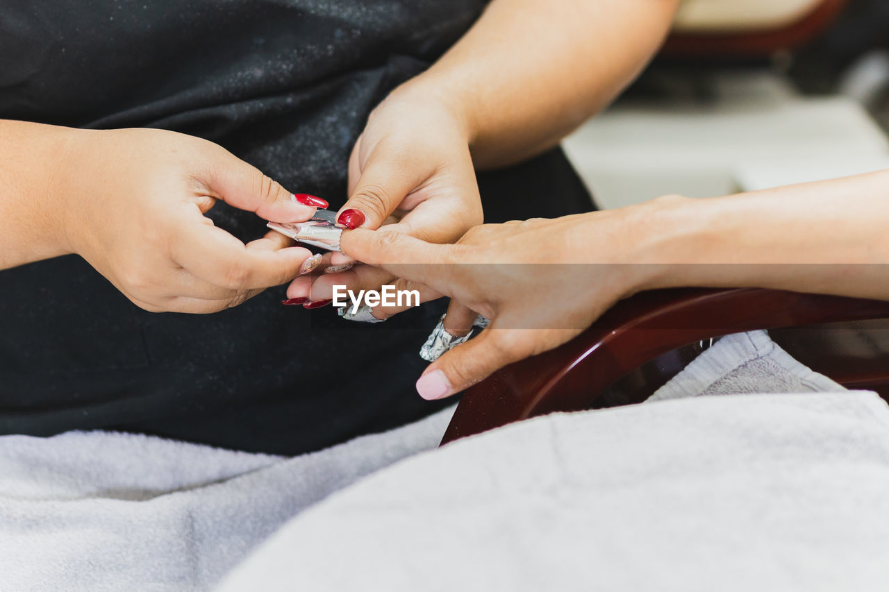 Woman getting a manicure in beauty spa salon