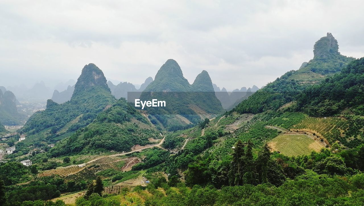 Scenic view of mountains against cloudy sky