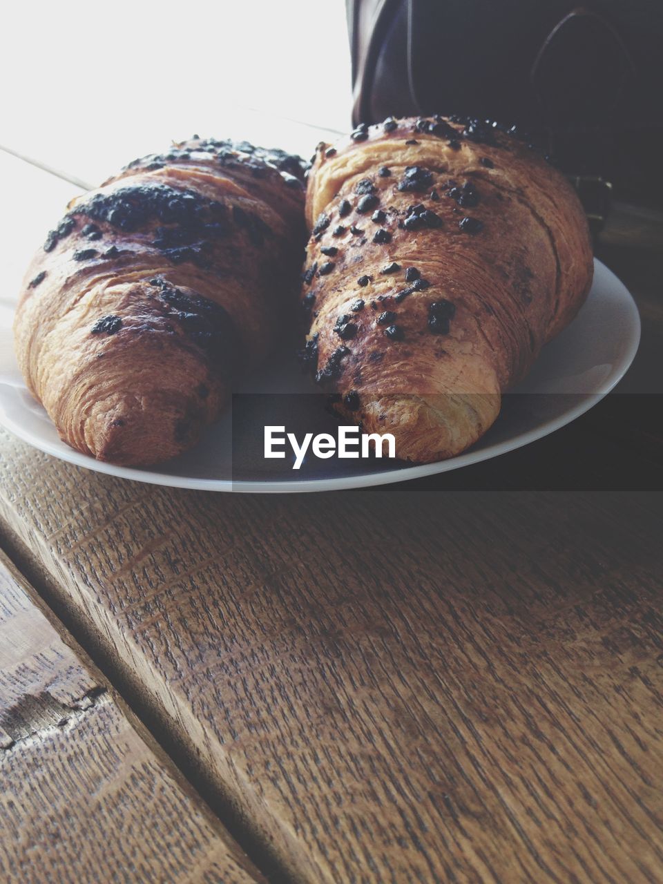 Croissants in plate on table