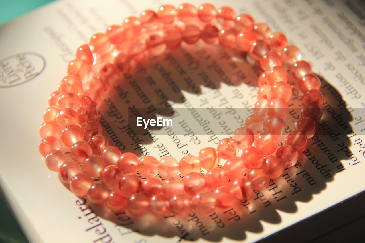 Close-up of beads bracelet on book