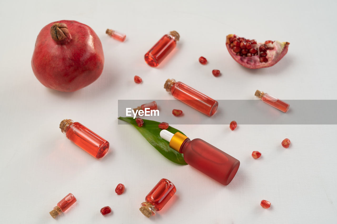 red, food and drink, food, healthy eating, studio shot, wellbeing, fruit, vitamin, no people, indoors, produce, medicine, capsule, still life, healthcare and medicine, pill, high angle view, large group of objects, freshness, nutritional supplement, pomegranate