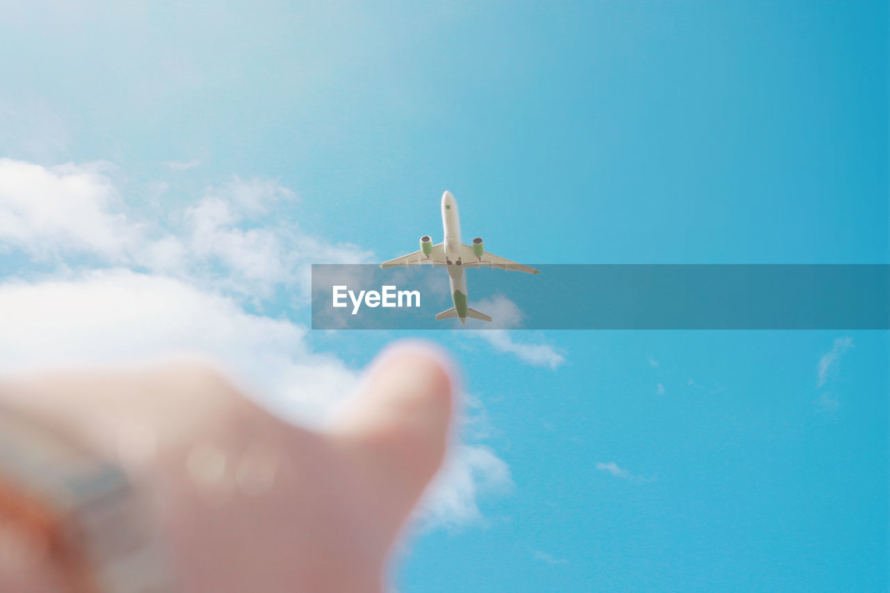 Low angle view of airplane flying against sky