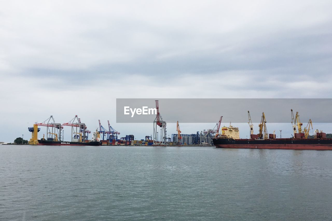 SILHOUETTE OF CRANES AT DOCK