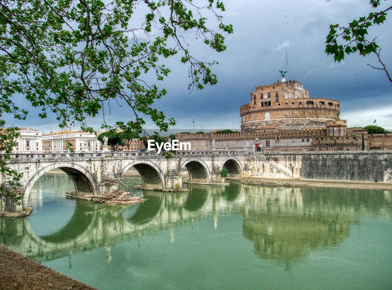 ARCH BRIDGE OVER LAKE BY BUILDINGS
