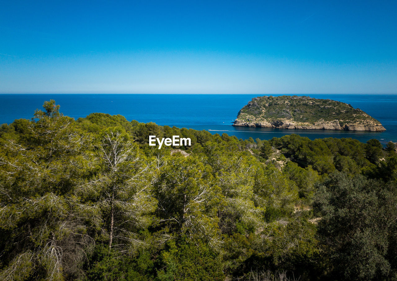 Scenic view of sea against clear blue sky