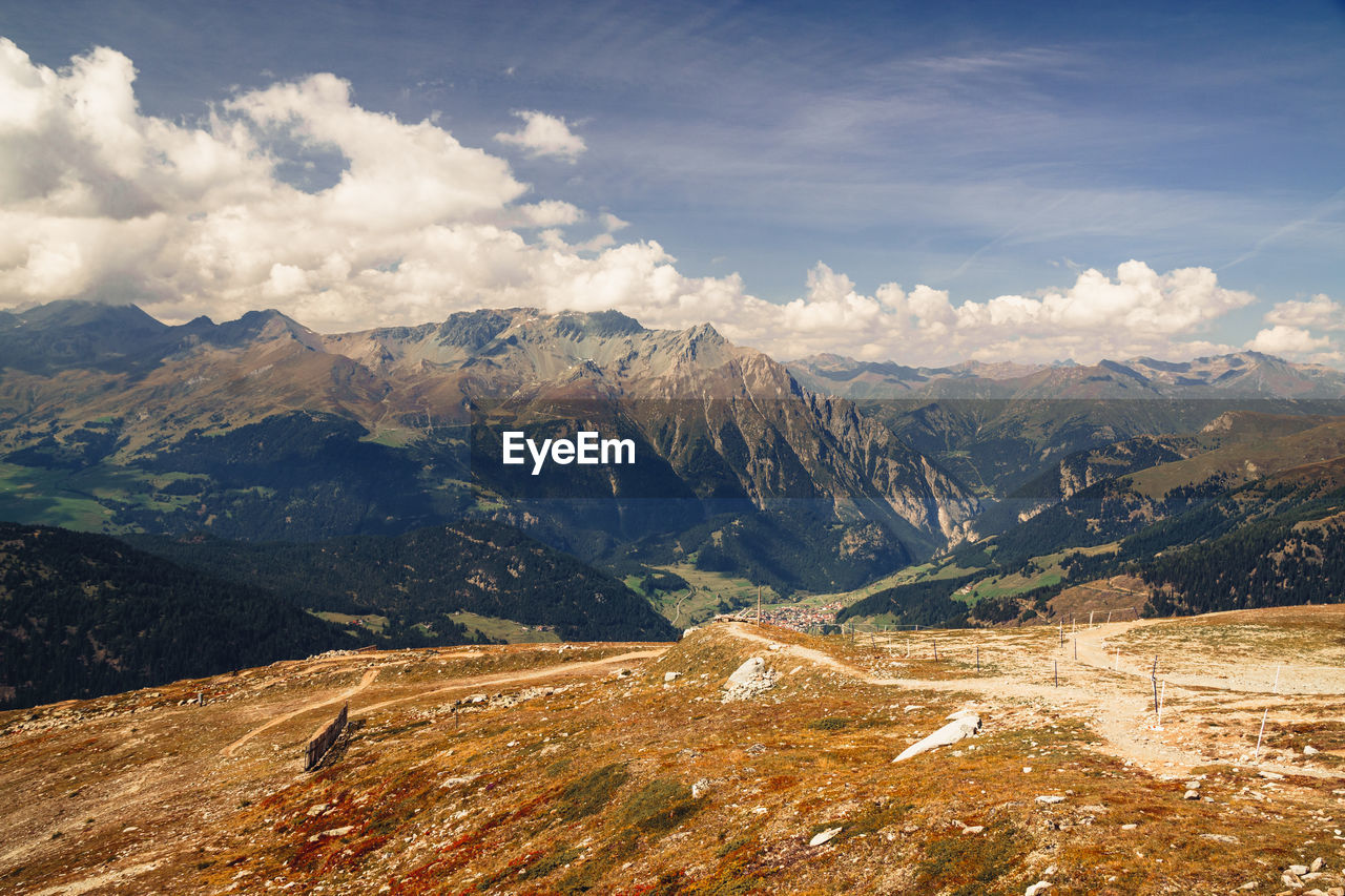 mountain, environment, landscape, scenics - nature, mountain range, nature, sky, beauty in nature, cloud, wilderness, snow, land, travel, travel destinations, cold temperature, tranquility, winter, valley, plateau, no people, tranquil scene, ridge, snowcapped mountain, non-urban scene, outdoors, tourism, mountain peak, pinaceae, day, coniferous tree, mountain pass, idyllic, pine tree, plant, rural scene, activity, vacation, sunlight, holiday, trip, blue, forest, extreme terrain, pine woodland, rock, tree
