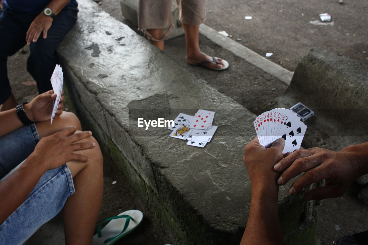 A group of men playing cards during their spare time.