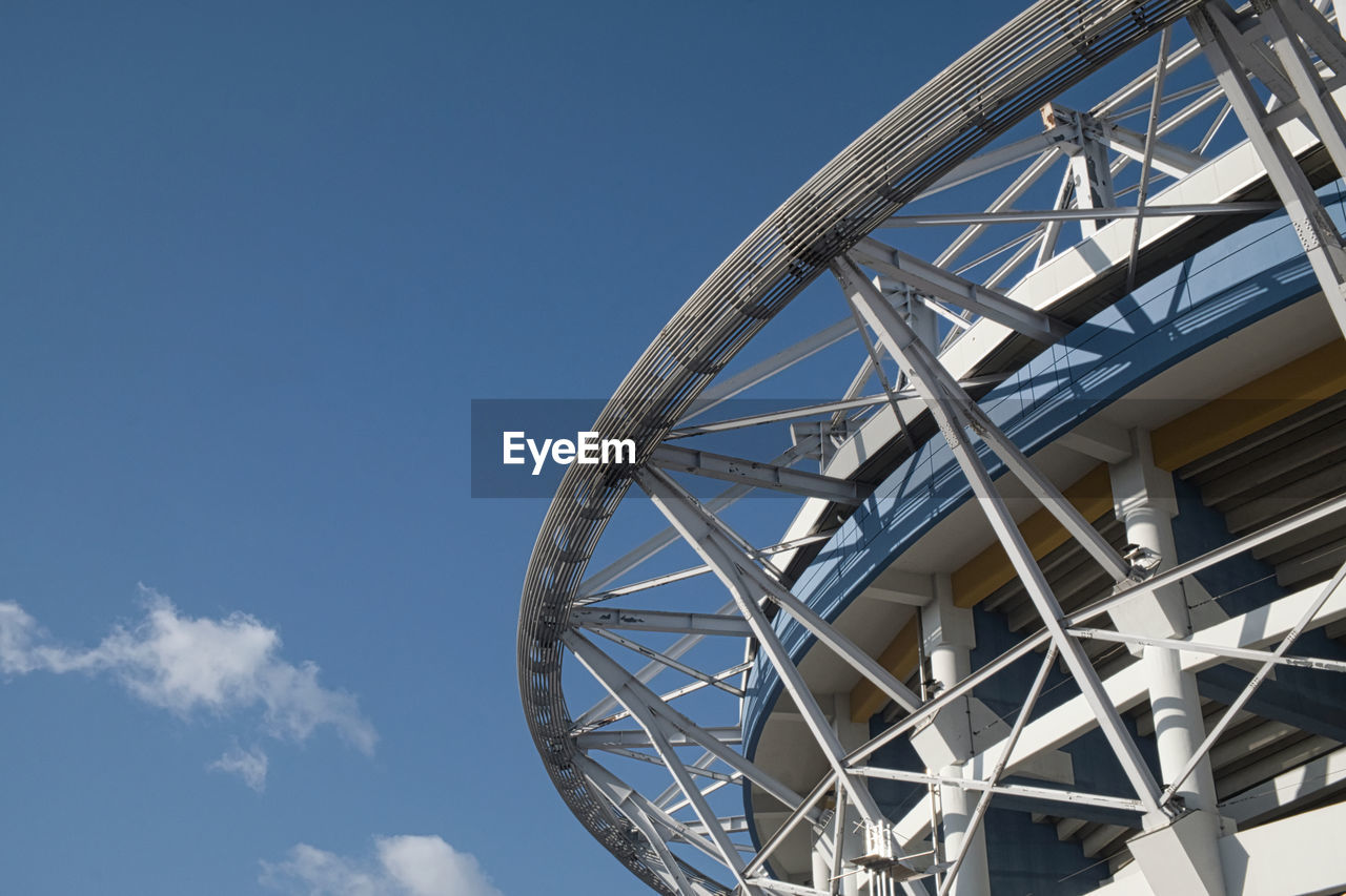 Low angle view of metallic structure against clear blue sky, worldcup stadium