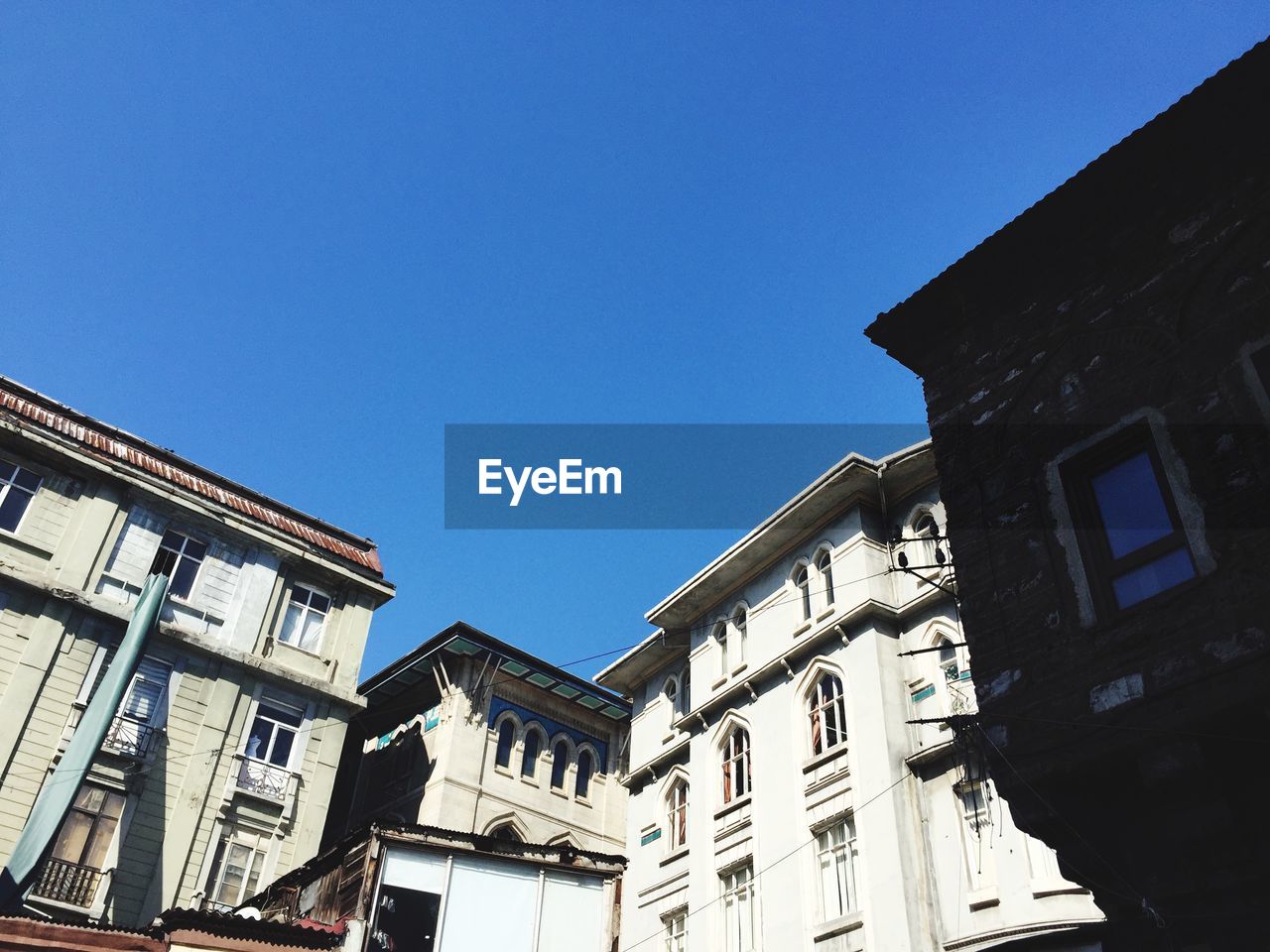 Low angle view of buildings against blue sky