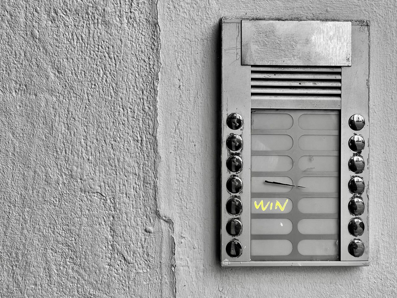 CLOSE-UP OF TELEPHONE BOOTH ON WALL OF DOOR